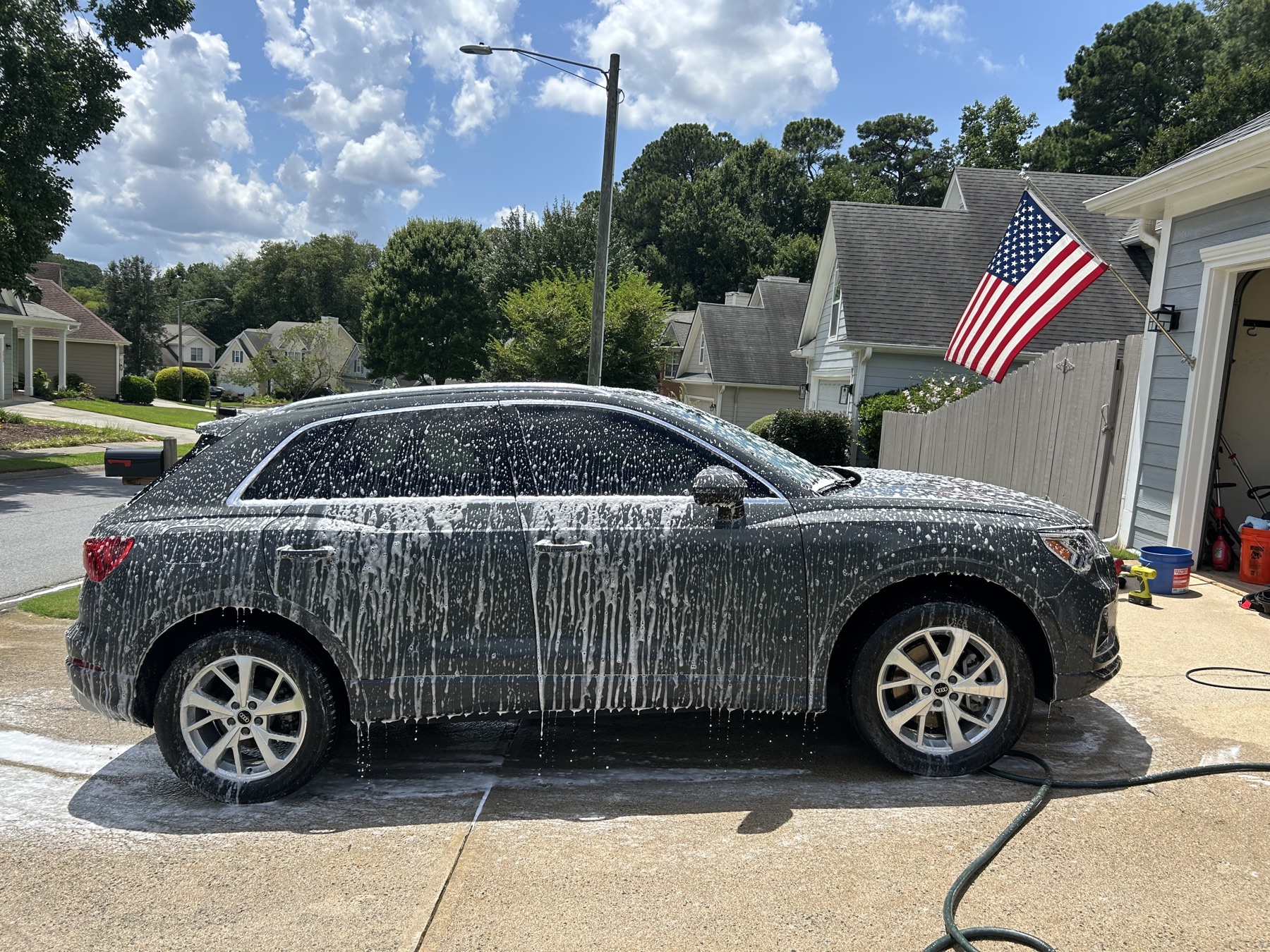 Blue Knight Detailing foam washing a white SUV