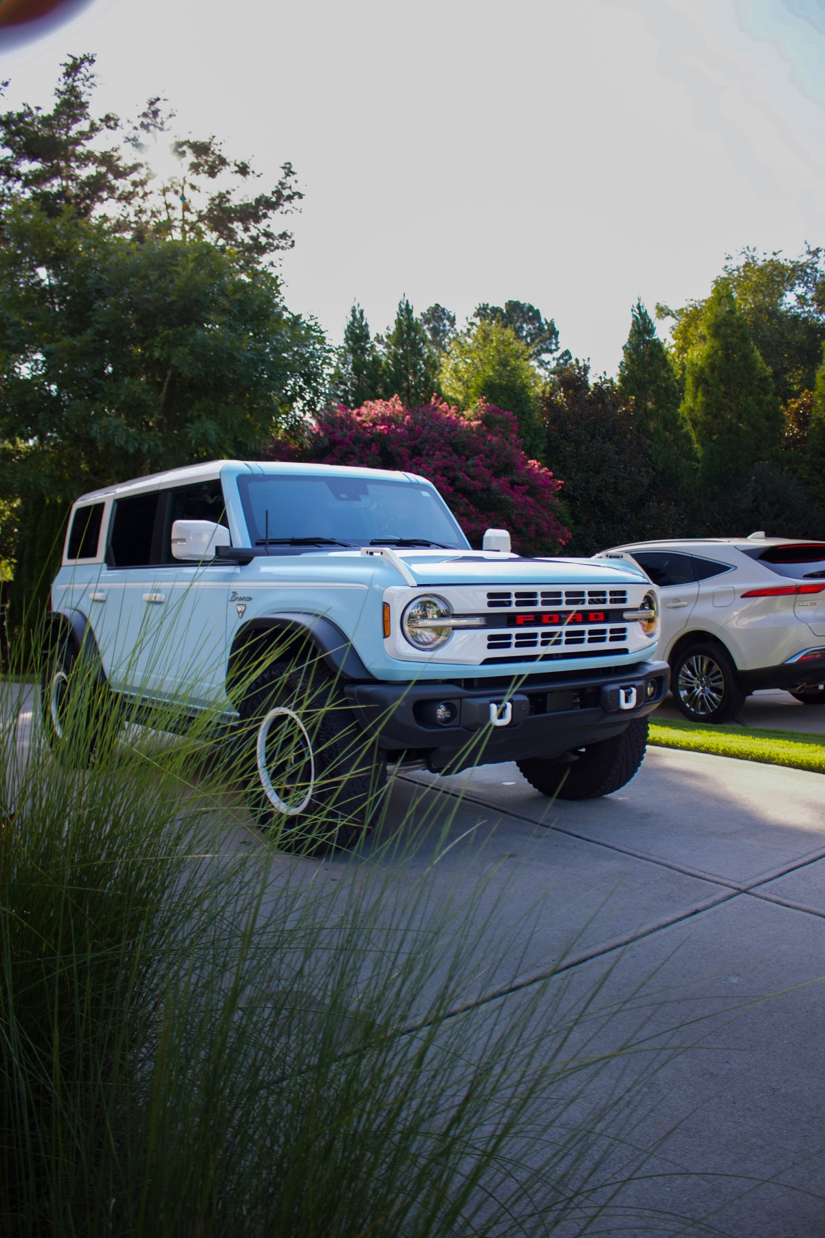 Light-blue Ford Bronco parked in a driveway after an exterior detail